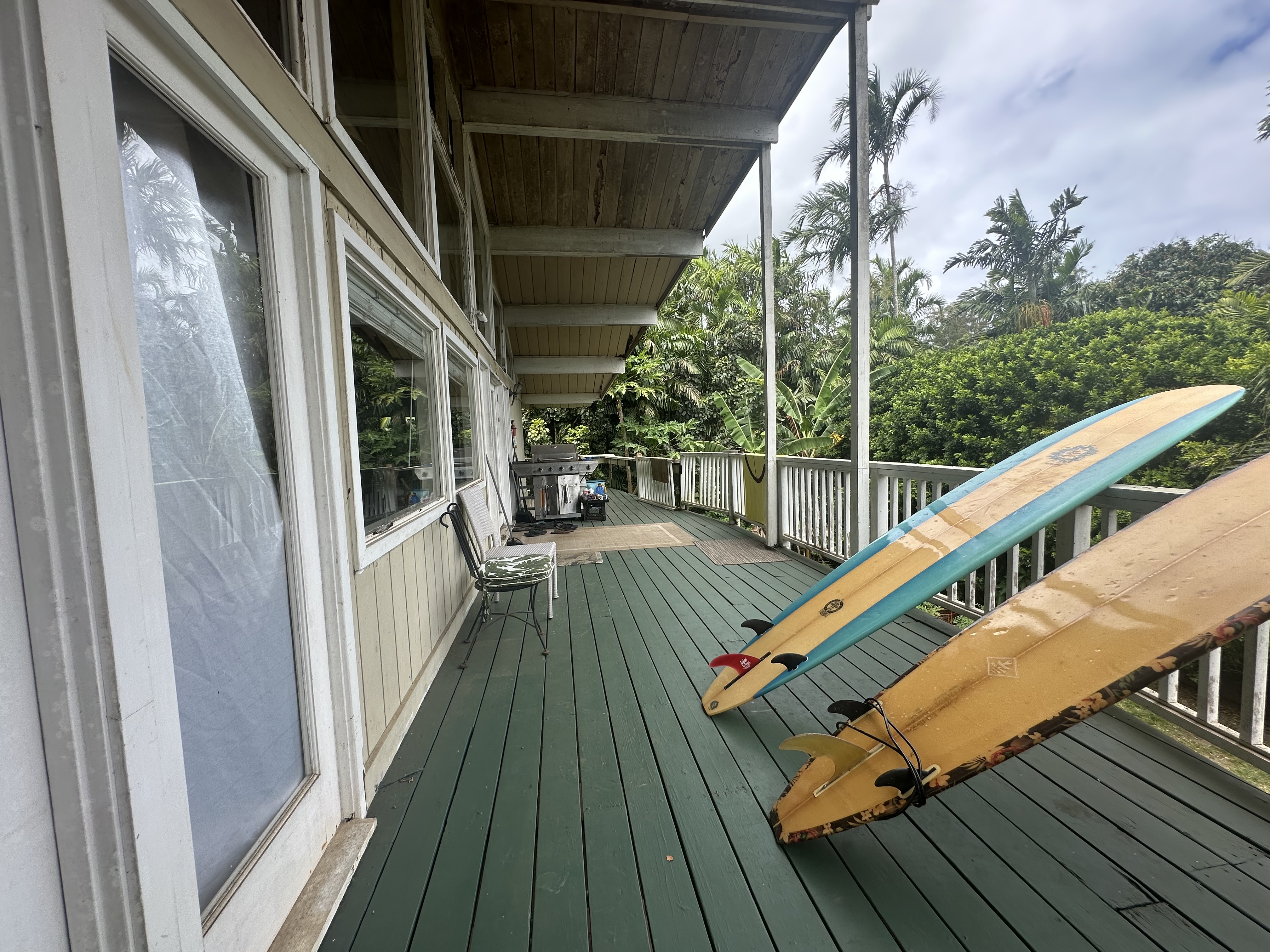 5404 Weke Road Hanalei, HI 96714 - Photo 12 of 19 a balcony with wooden floor and furniture