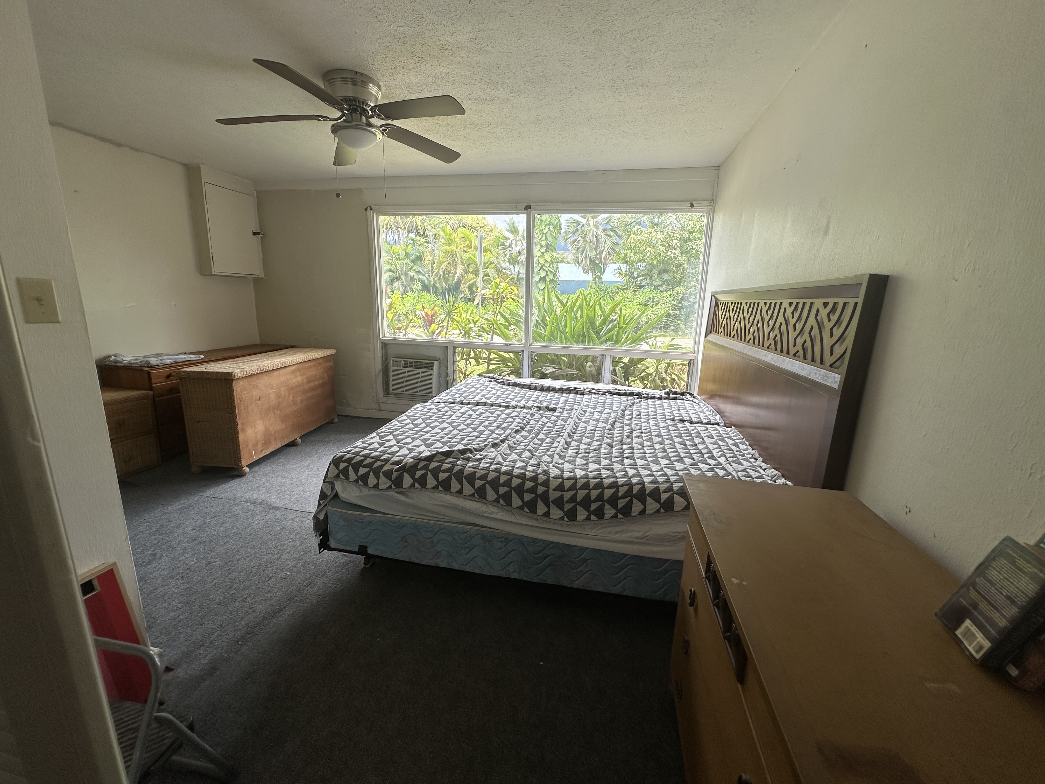 5404 Weke Road Hanalei, HI 96714 - Photo 13 of 19 a bed sitting in a bedroom next to a window