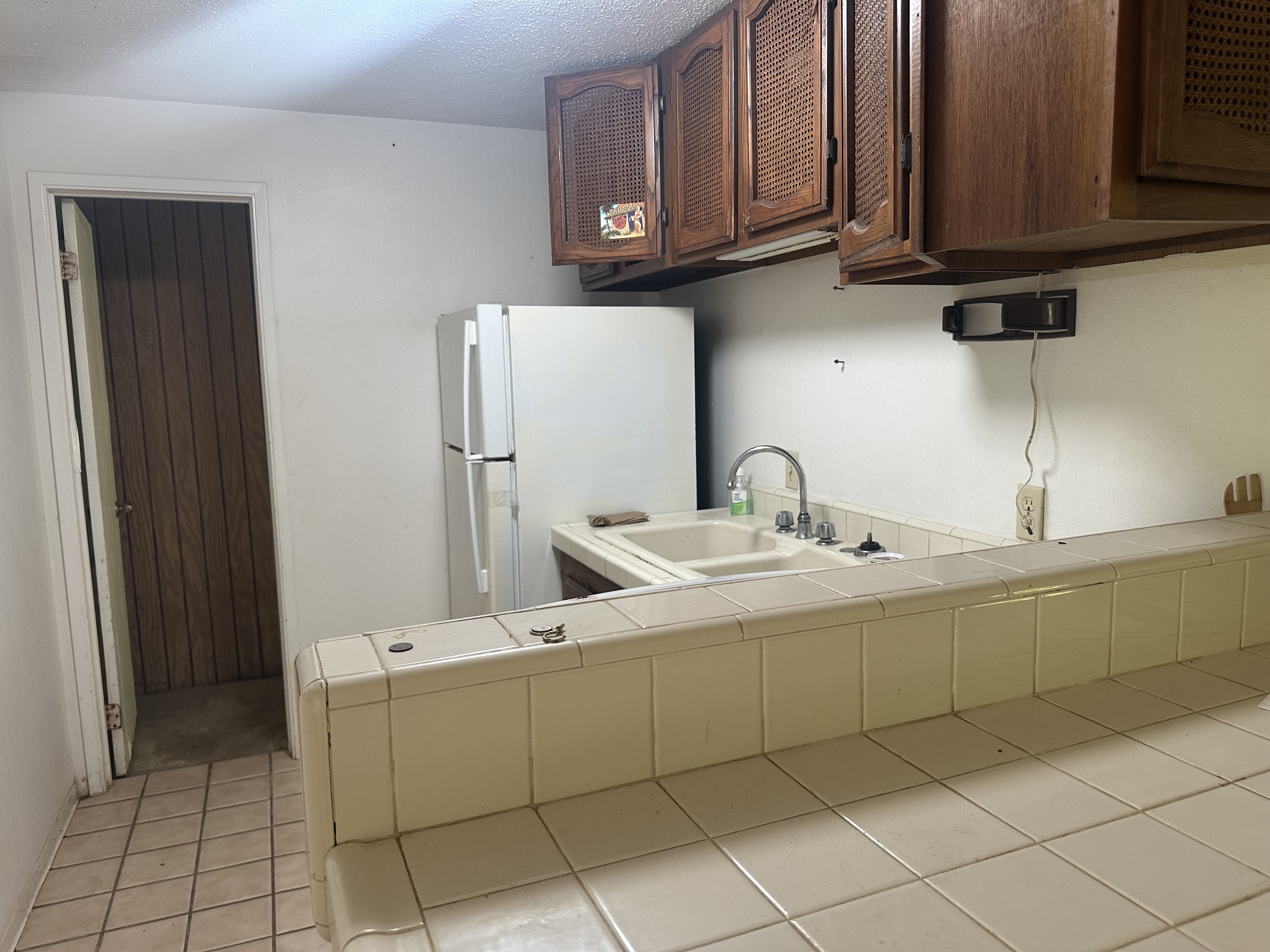 5404 Weke Road Hanalei, HI 96714 - Photo 15 of 19 a kitchen with a sink and cabinets