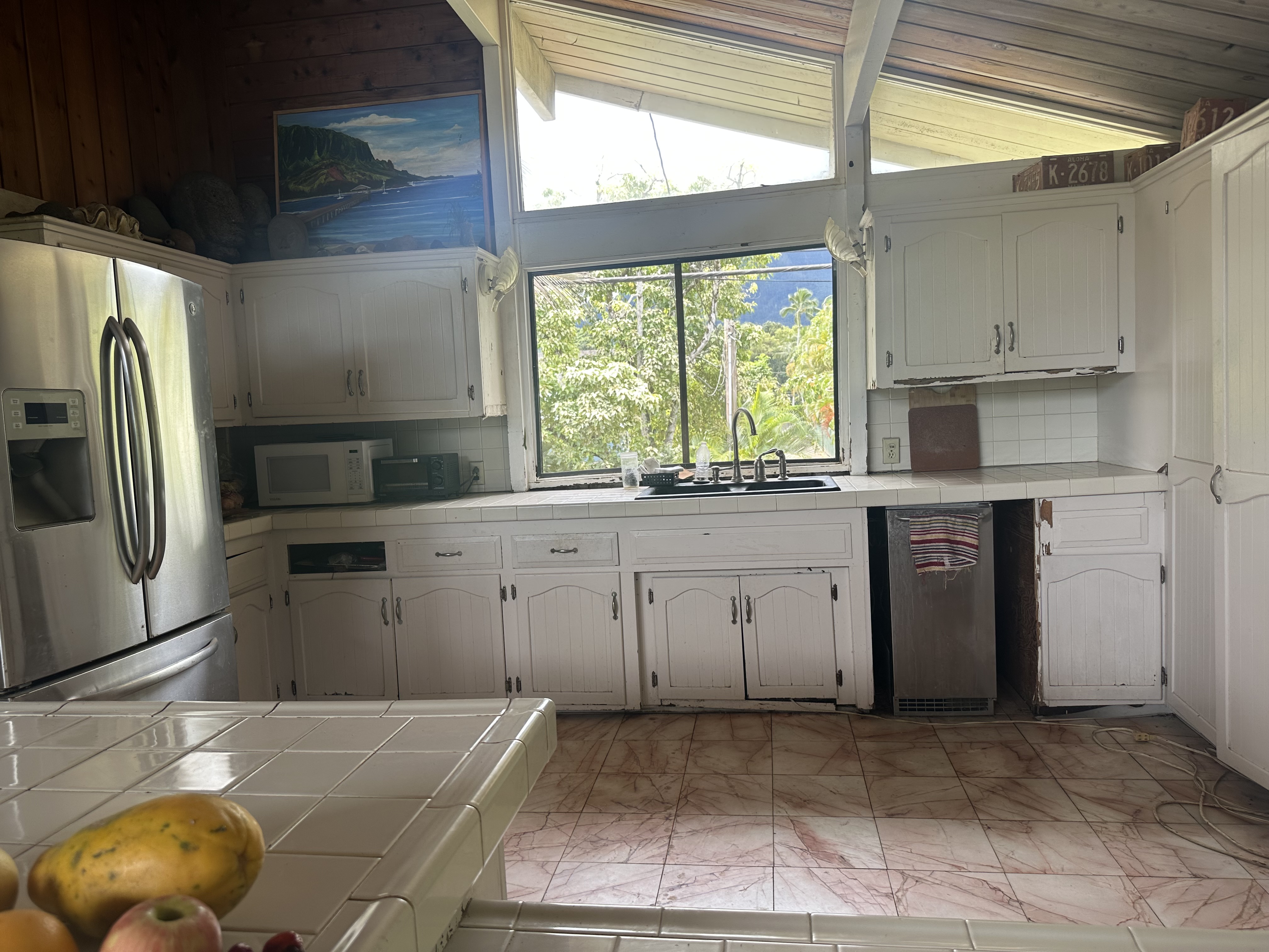 5404 Weke Road Hanalei, HI 96714 - Photo 17 of 19 a kitchen with a sink stove and cabinets