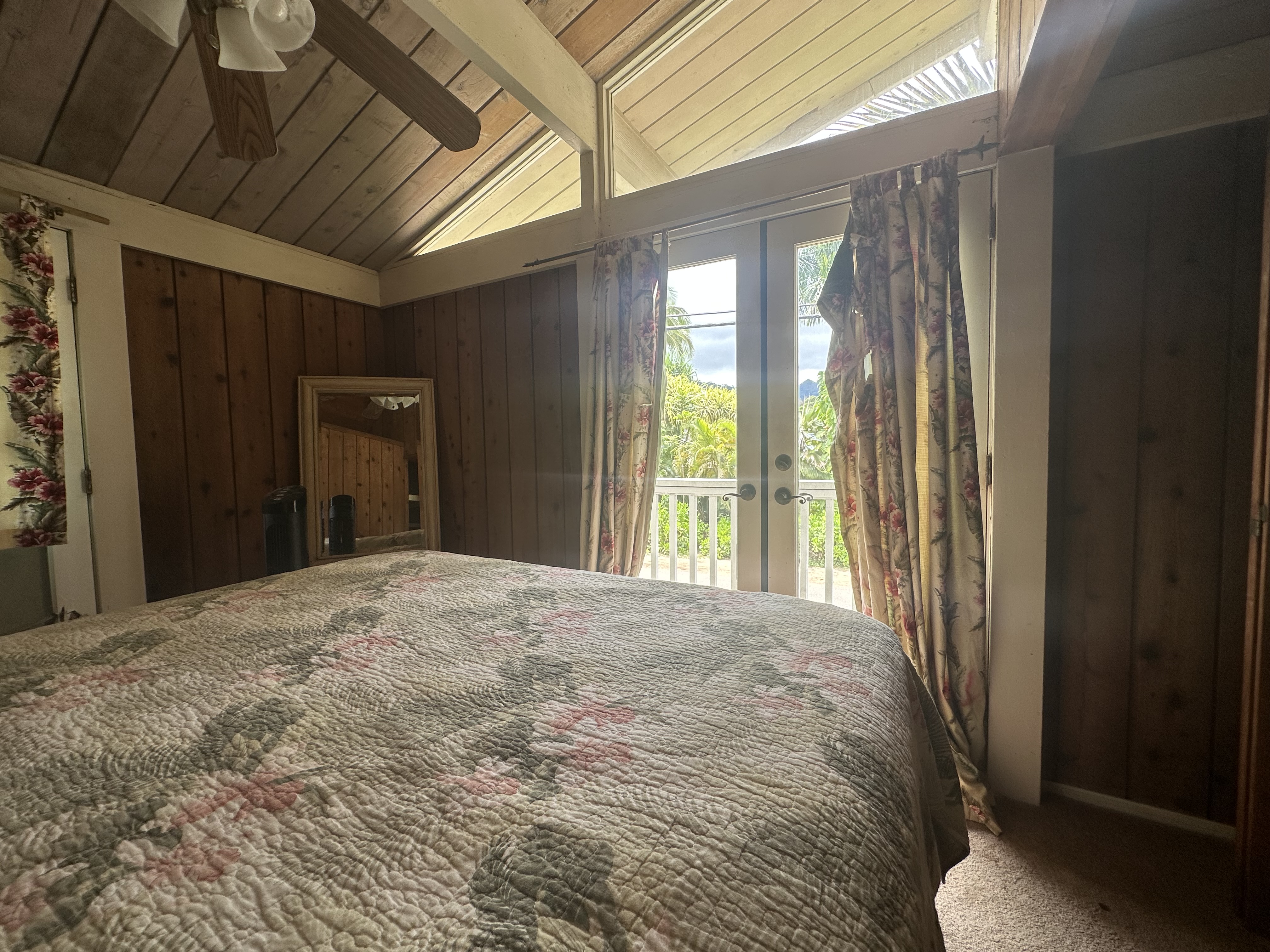 5404 Weke Road Hanalei, HI 96714 - Photo 6 of 19 a bedroom with a bed and a large window