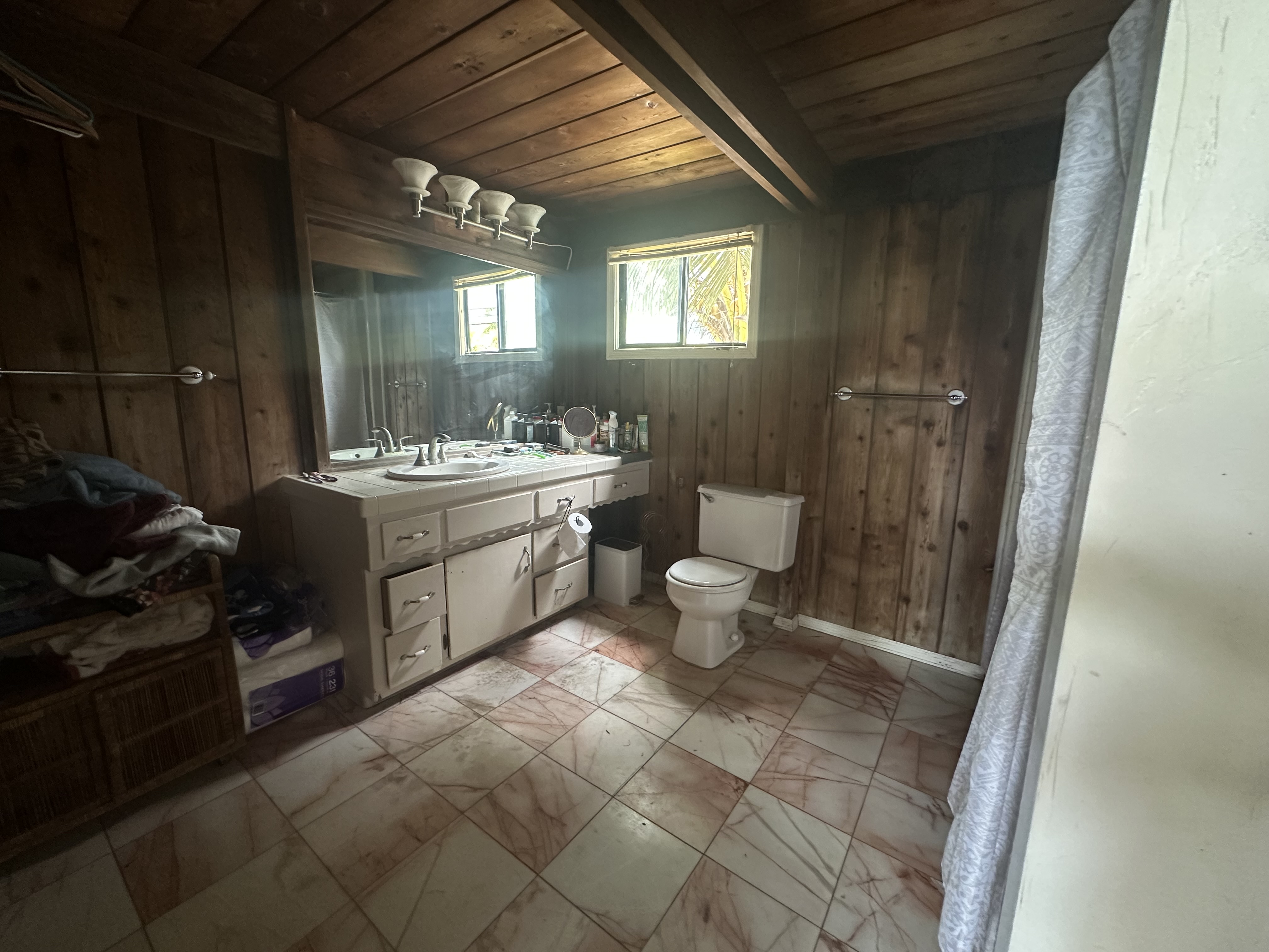 5404 Weke Road Hanalei, HI 96714 - Photo 8 of 19 a bathroom with a toilet a sink and mirror