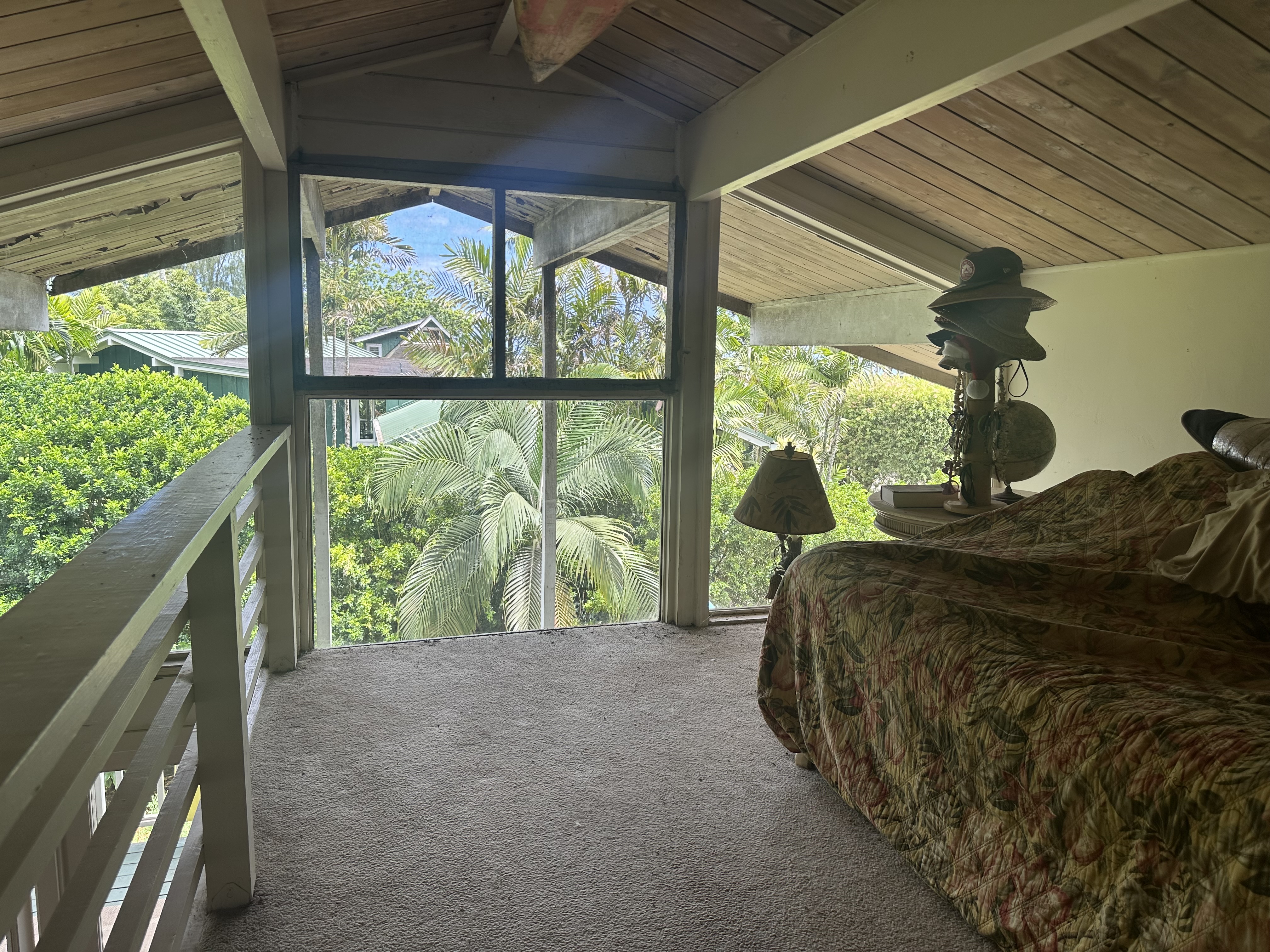 5404 Weke Road Hanalei, HI 96714 - Photo 9 of 19 a bed sitting in a bedroom next to a large window