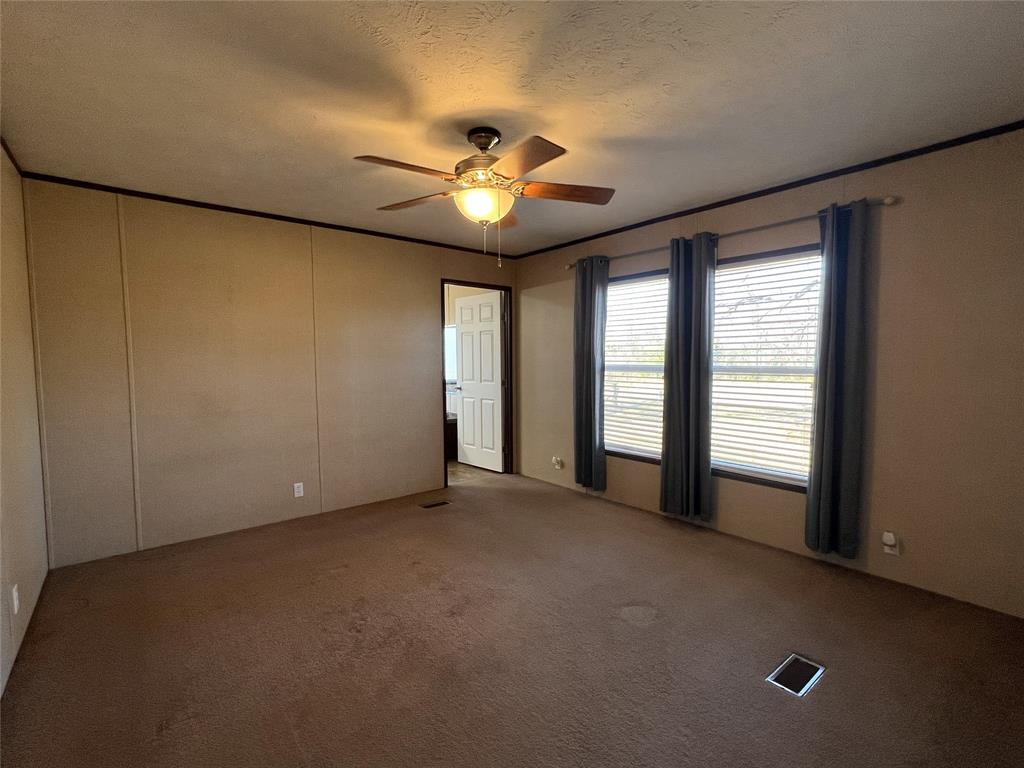 1100 County Road 3531 Saltillo, TX 75478 - Photo 15 of 29 a view of an empty room with chandelier fan and fire place