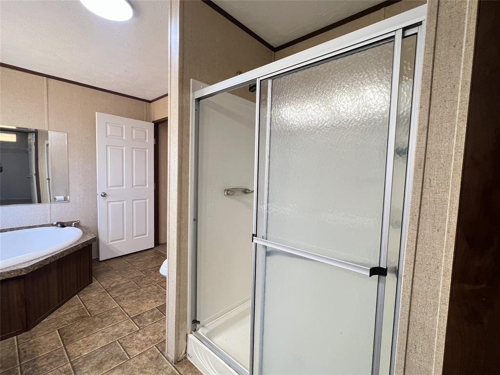 1100 County Road 3531 Saltillo, TX 75478 - Photo 19 of 29 a bathroom with a tub and shower