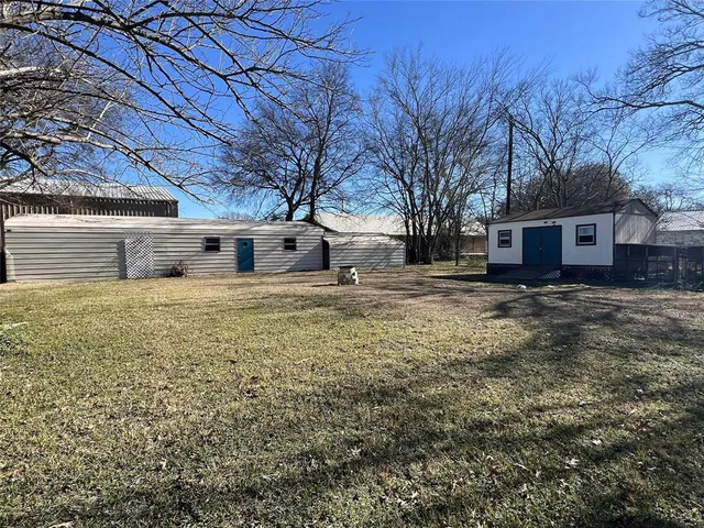 a large tree in front of a house