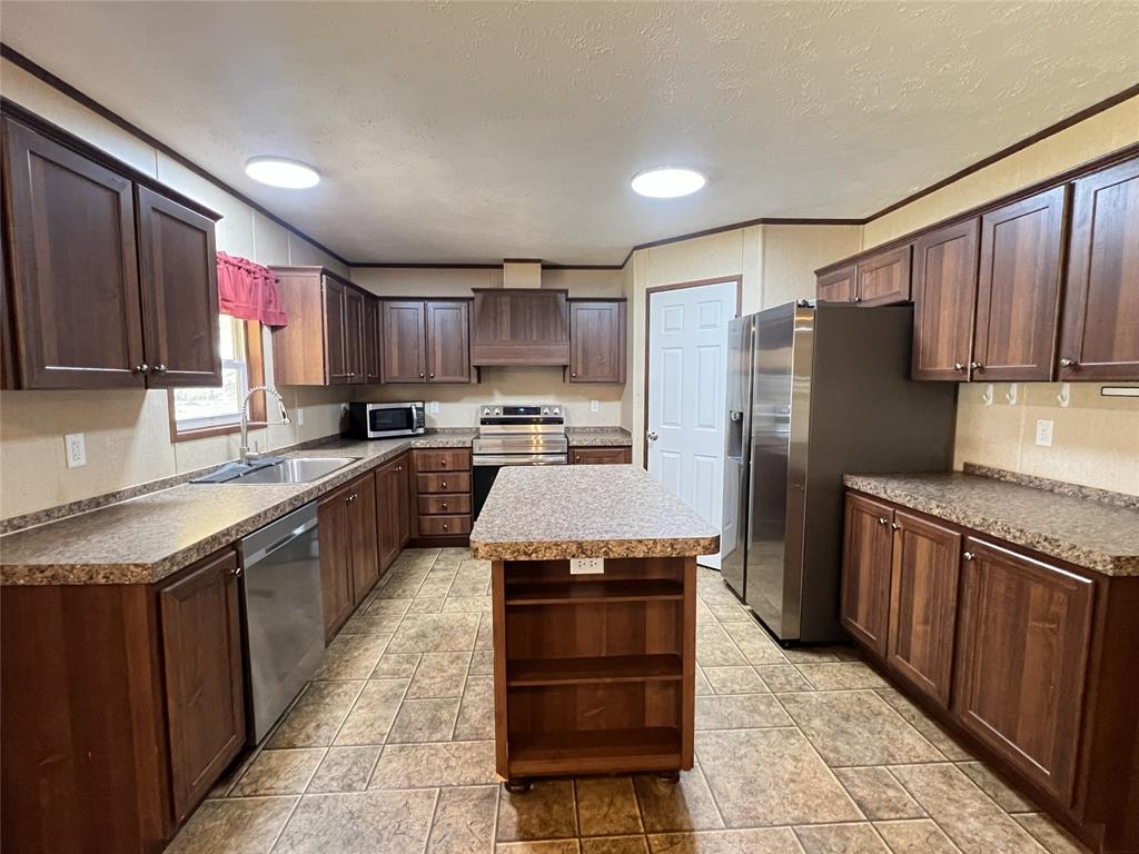1100 County Road 3531 Saltillo, TX 75478 - Photo 6 of 29 a kitchen with stainless steel appliances granite countertop a stove refrigerator sink and cabinets