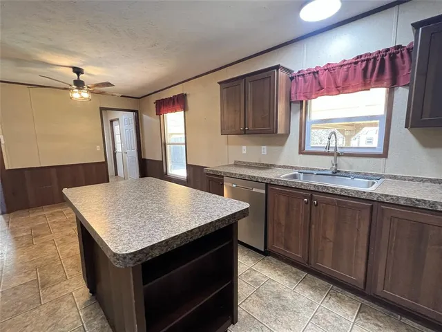 a kitchen with a stove a sink and a refrigerator