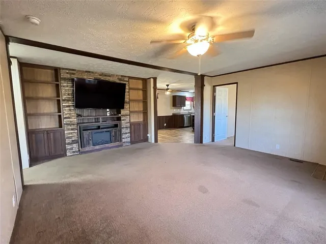 a view of a livingroom with entryway cabinet and a flat screen tv