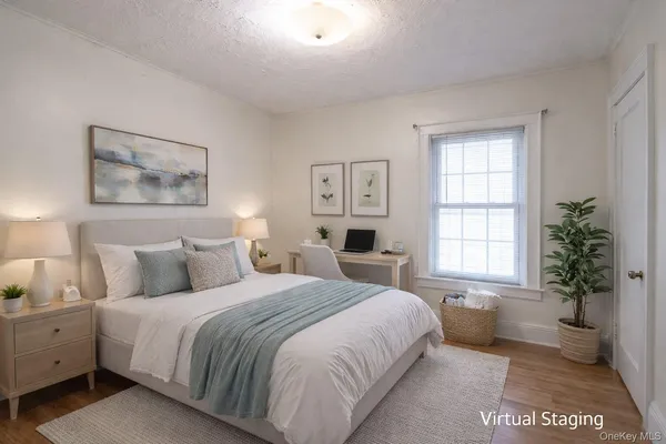 a bedroom with a large bed and a potted plant