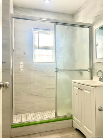 a bathroom with a shower and a sink
