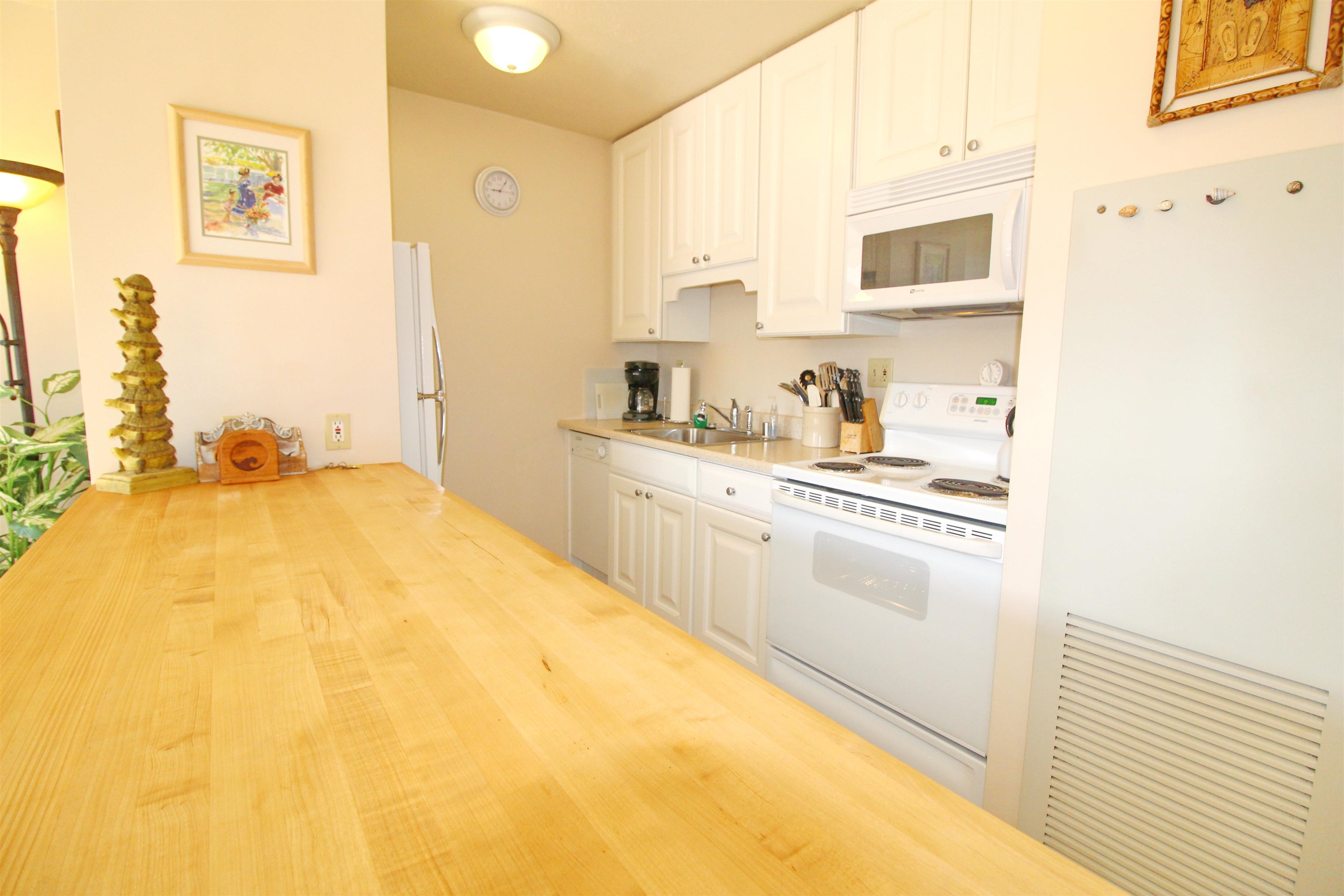 145 North Kihei Road, Unit 503 Kihei, HI 96753 - Photo 11 of 30 a large white kitchen with granite countertop a sink