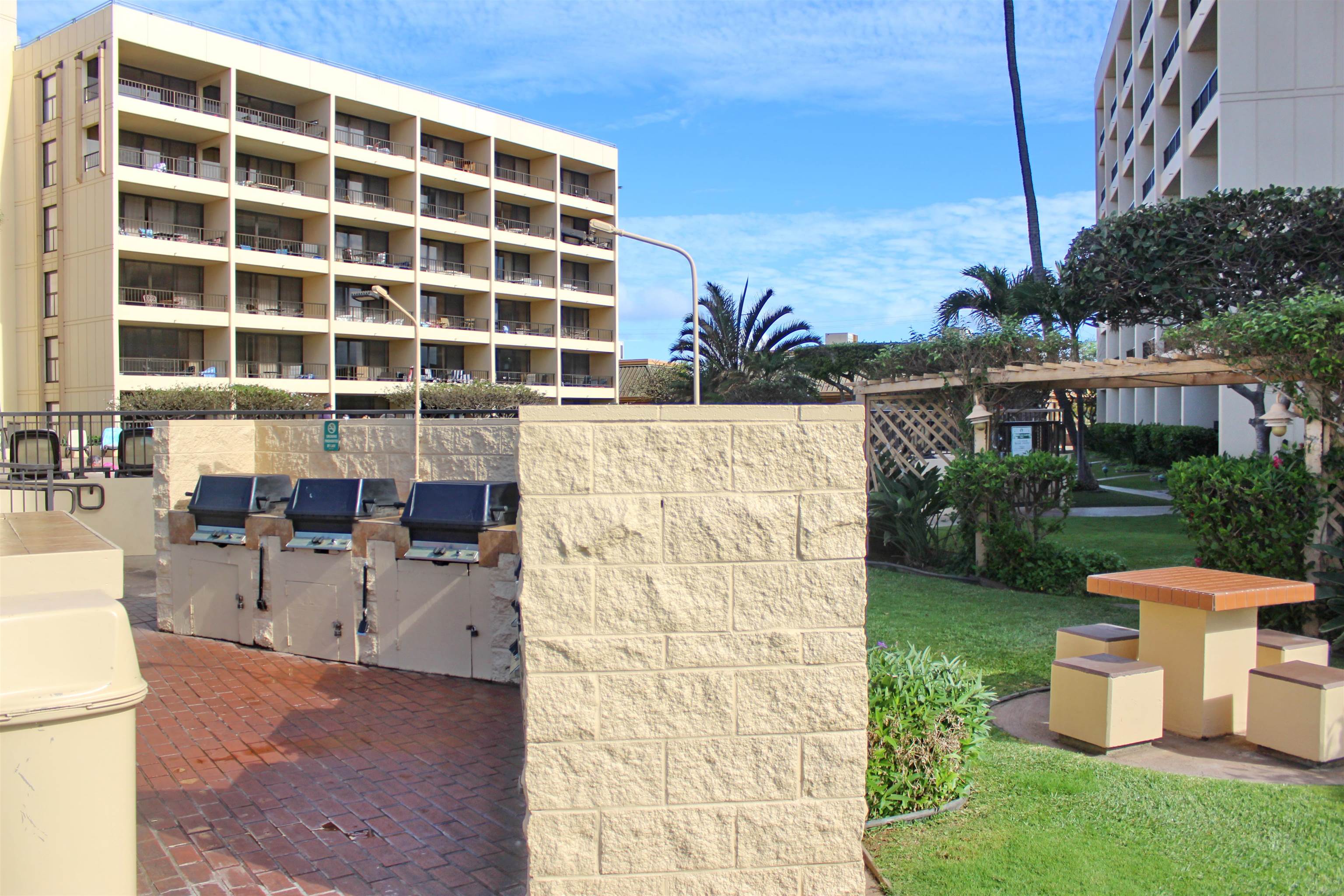145 North Kihei Road, Unit 503 Kihei, HI 96753 - Photo 23 of 30 a view of a patio with a table and chairs and potted plants