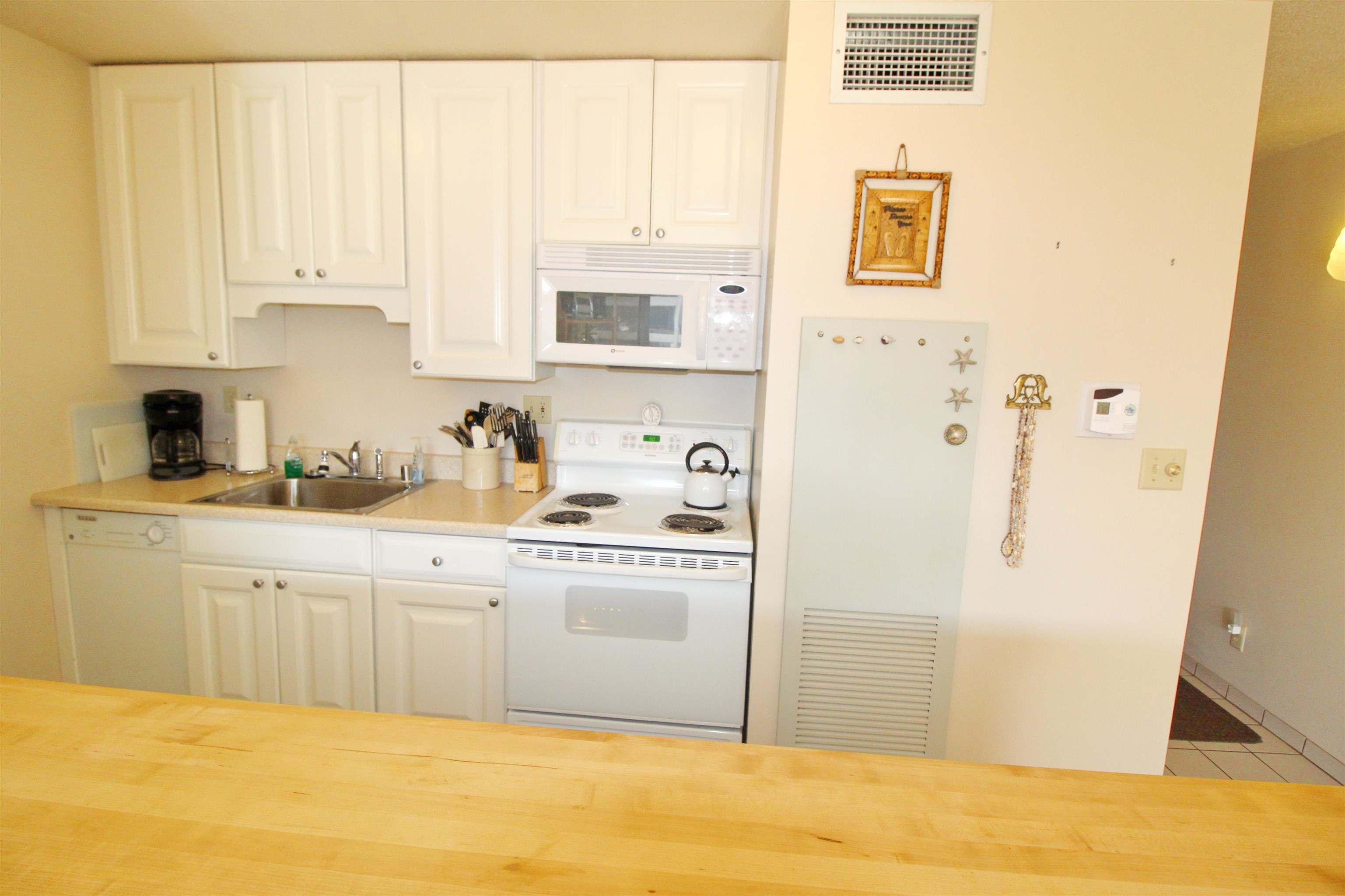 145 North Kihei Road, Unit 503 Kihei, HI 96753 - Photo 10 of 30 a white kitchen with a sink