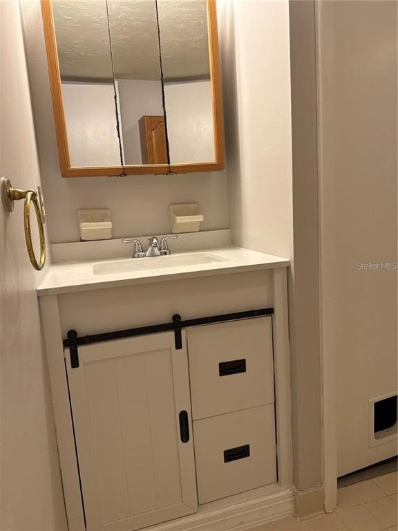 4313 Southwest 68th Terrace Gainesville, FL 32608 - Photo 10 of 14 a bathroom with a sink and a mirror