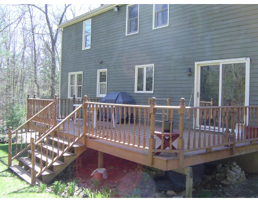 16 Johnson Road Sutton, MA 01590 - Photo 4 of 7 a view of a wooden deck with a bench