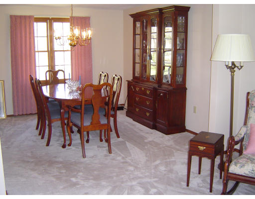 16 Johnson Road Sutton, MA 01590 - Photo 5 of 7 a view of a dining room with furniture and chandelier