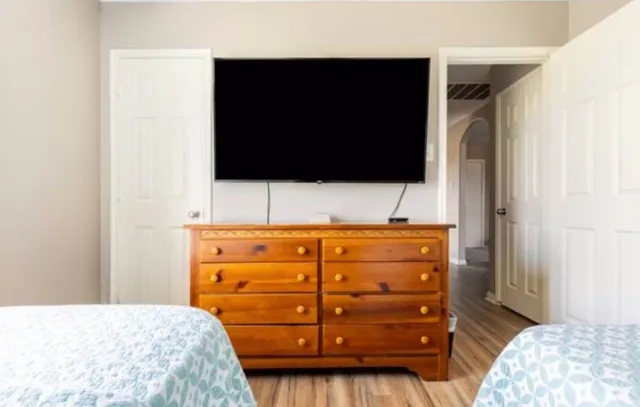 a bedroom with a bed and a flat tv screen