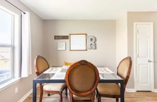 a dining room with furniture and window