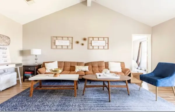 a living room with furniture and a rug