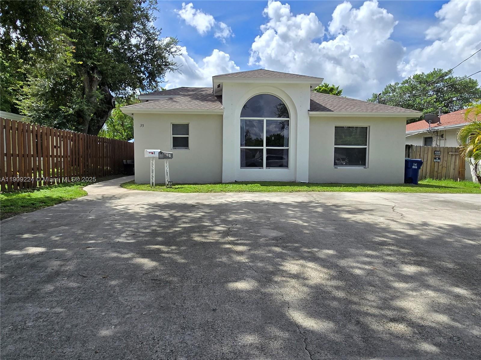 a view of a house with garden and trees