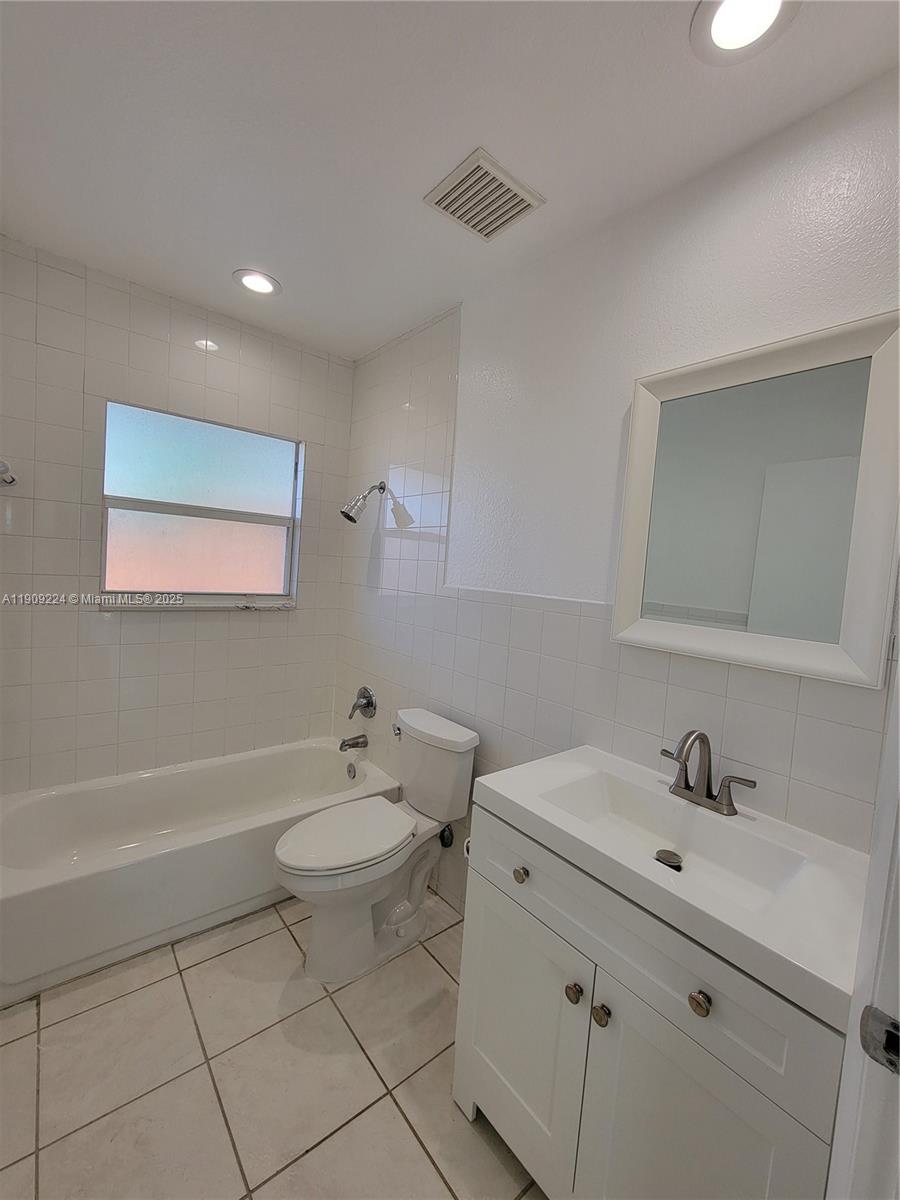 35 Southwest 7th Street, Unit 2 Hallandale Beach, FL 33009 - Photo 12 of 23 a bathroom with a sink a toilet and shower