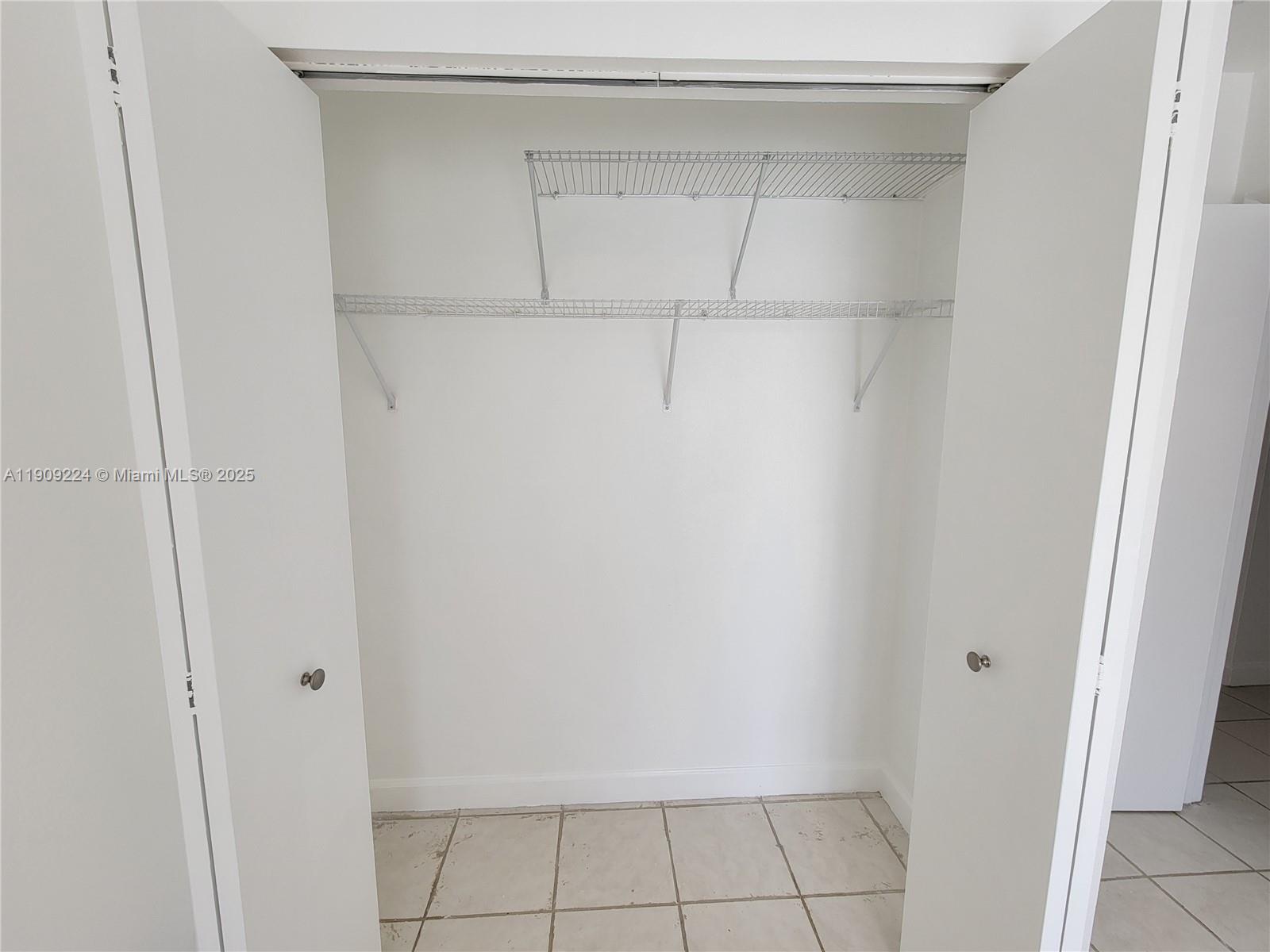 35 Southwest 7th Street, Unit 2 Hallandale Beach, FL 33009 - Photo 14 of 23 a view of an empty walk in closet