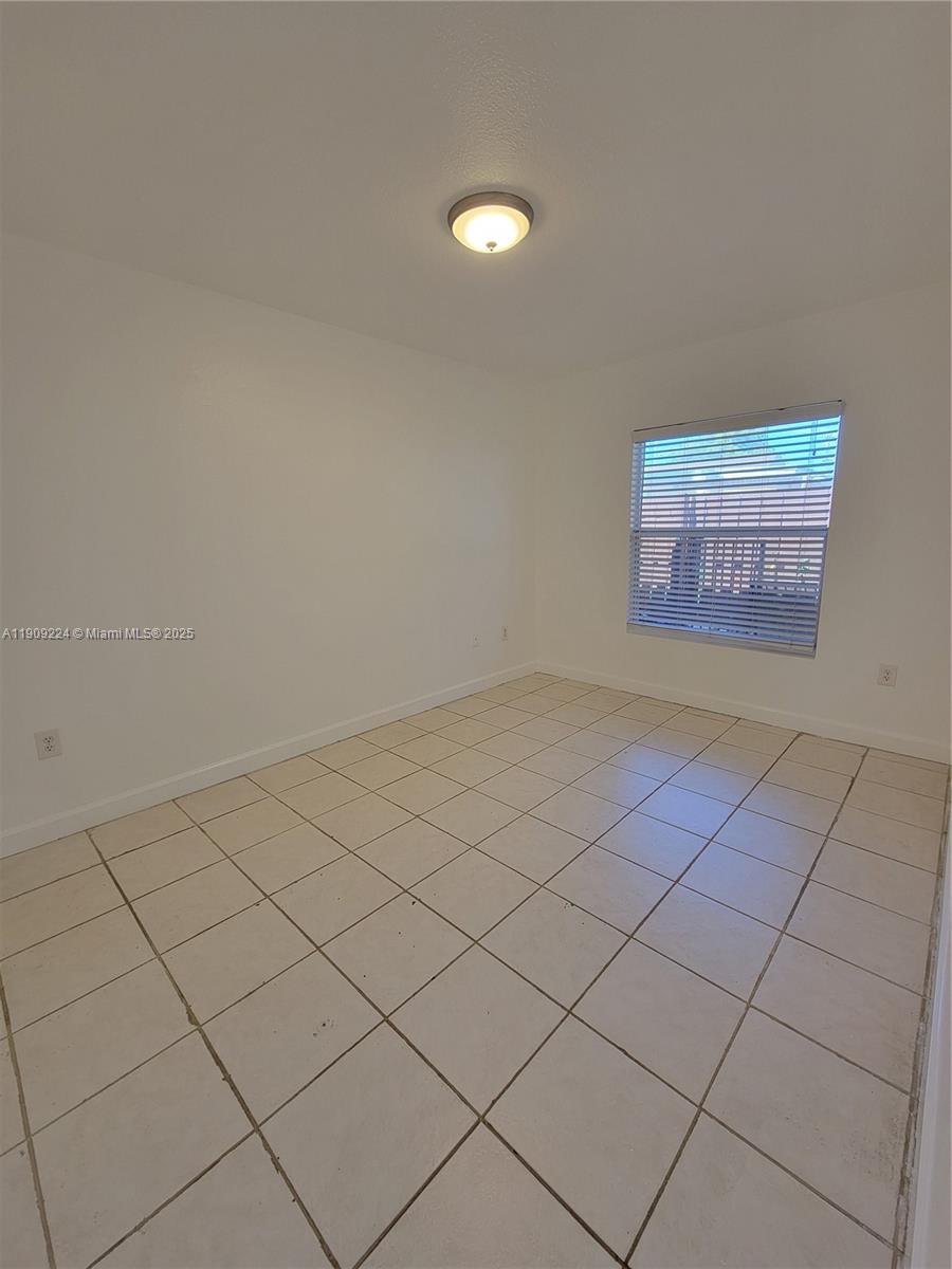 35 Southwest 7th Street, Unit 2 Hallandale Beach, FL 33009 - Photo 15 of 23 a view of an empty room and a window