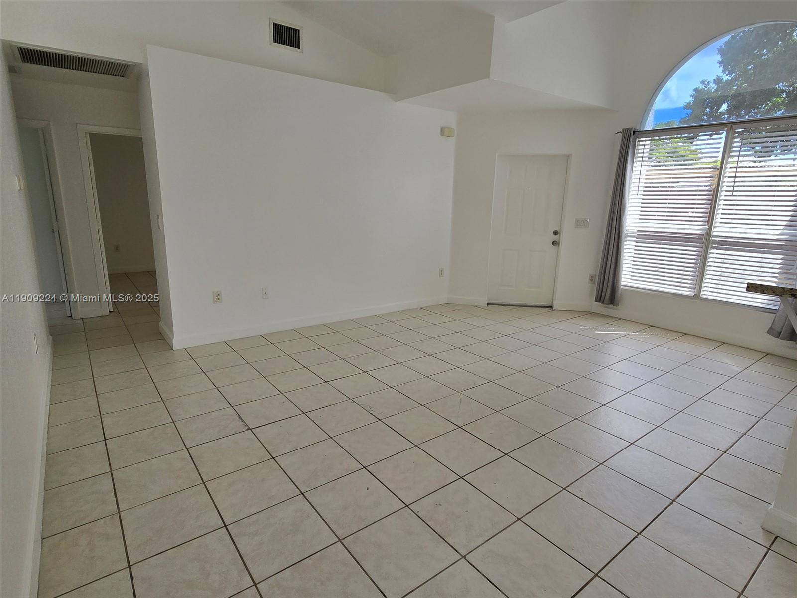 35 Southwest 7th Street, Unit 2 Hallandale Beach, FL 33009 - Photo 18 of 23 an empty room with windows