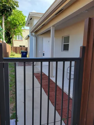 a view of a house with backyard and deck
