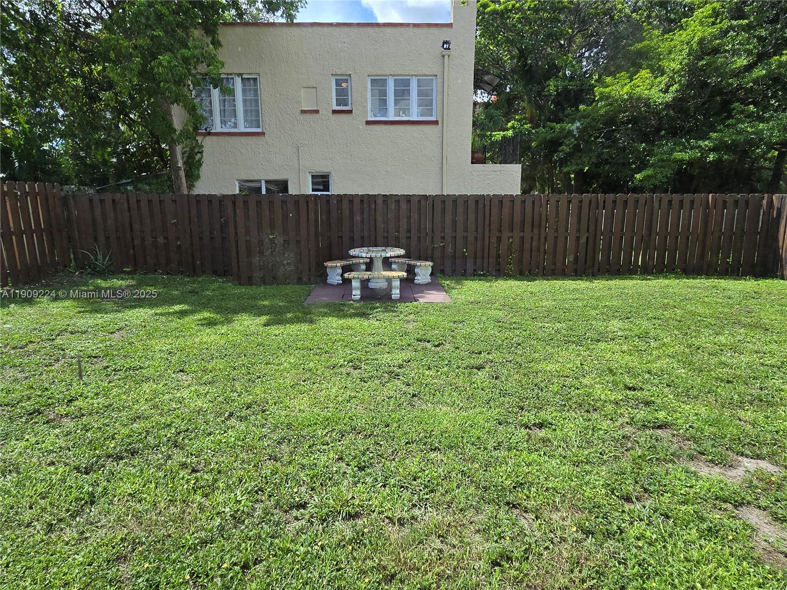 35 Southwest 7th Street, Unit 2 Hallandale Beach, FL 33009 - Photo 23 of 23 a view of a backyard with a garden and deck