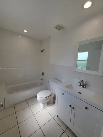 a bathroom with a sink a toilet and bathtub