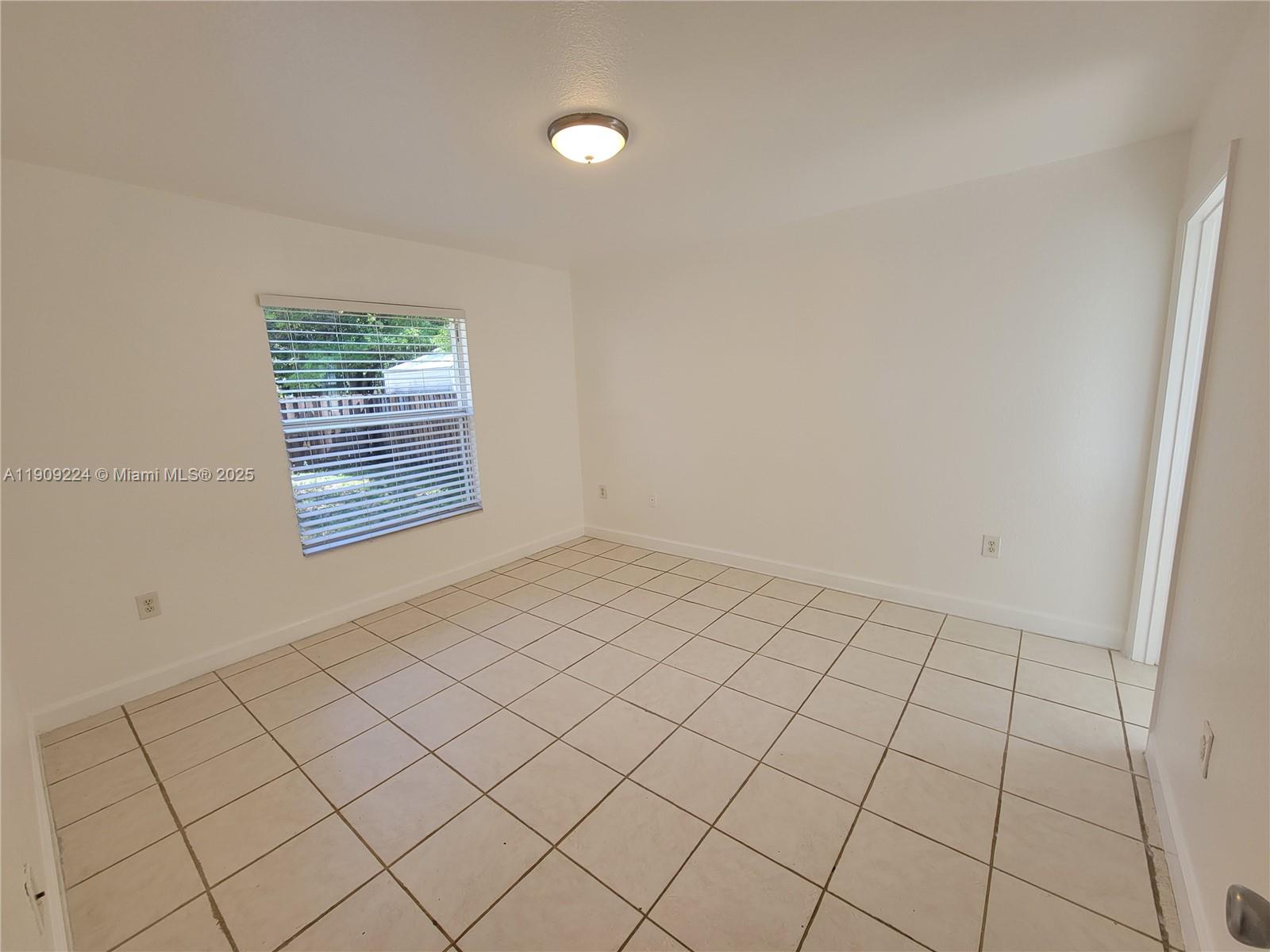 35 Southwest 7th Street, Unit 2 Hallandale Beach, FL 33009 - Photo 9 of 23 an empty room with windows