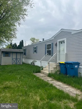 a front view of a house with a yard and wooden fence
