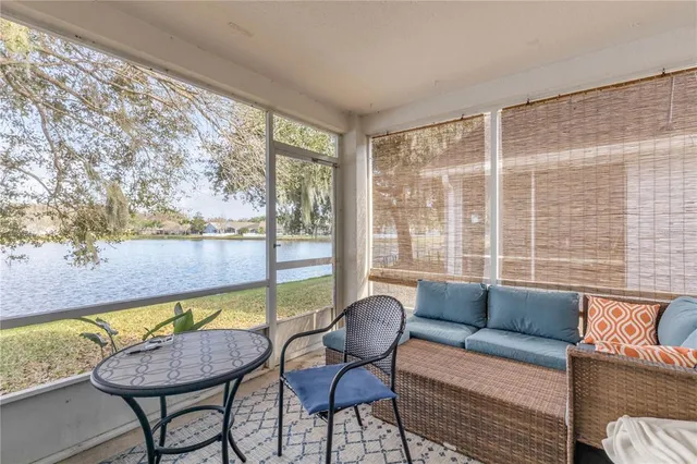 an aerial view of ocean and residential houses with outdoor space