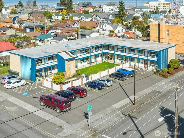 an aerial view of a swimming pool with outdoor seating