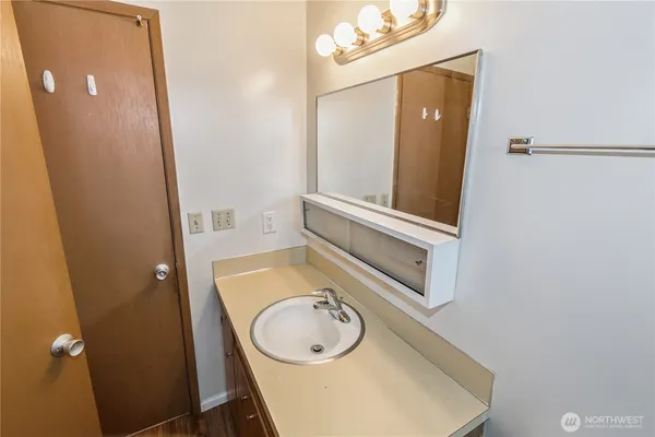 a bathroom with a sink a mirror and a toilet