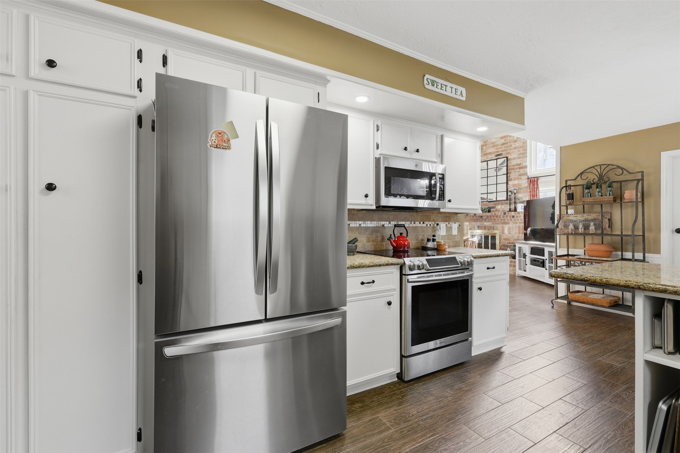 3415 Flickering Candle Drive Spring, TX 77388 - Photo 13 of 36 a kitchen with stainless steel appliances a refrigerator a stove a sink a dining table and chairs
