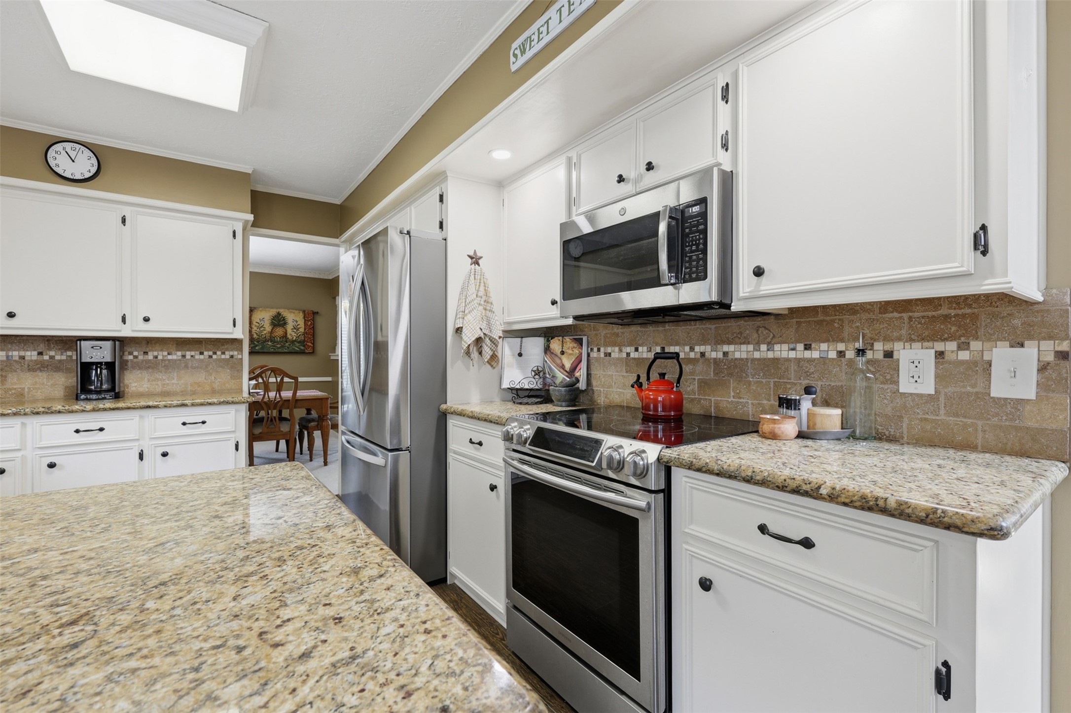 3415 Flickering Candle Drive Spring, TX 77388 - Photo 14 of 36 a kitchen with granite countertop a sink stainless steel appliances and cabinets