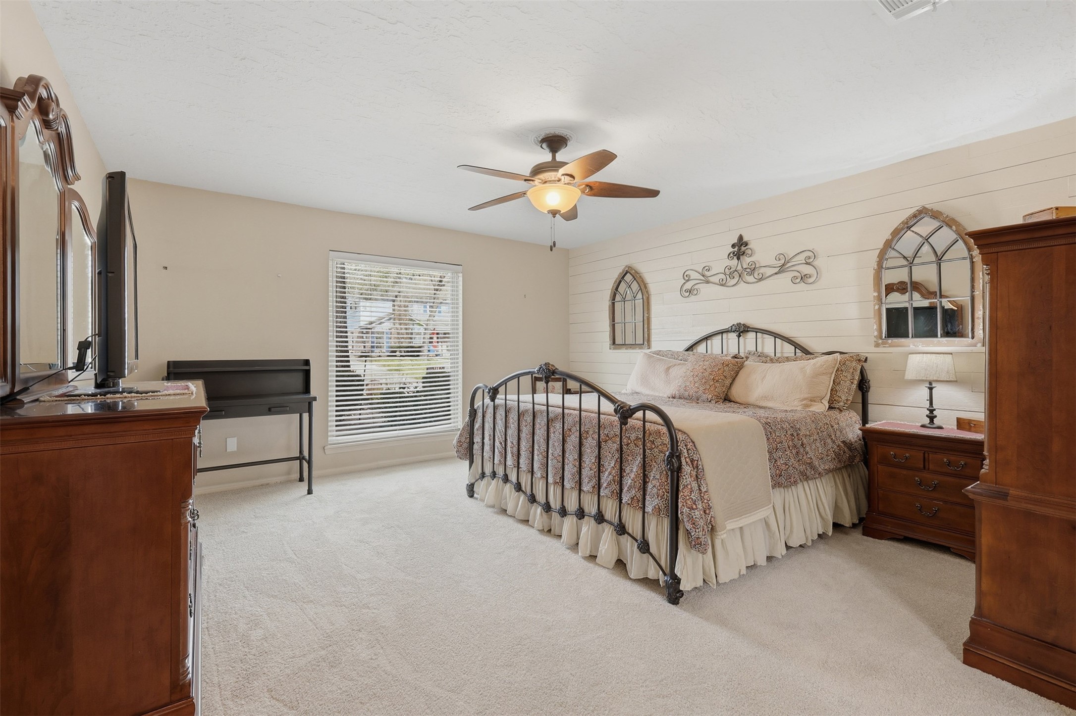 3415 Flickering Candle Drive Spring, TX 77388 - Photo 17 of 36 a spacious bedroom with a bed and a chandelier
