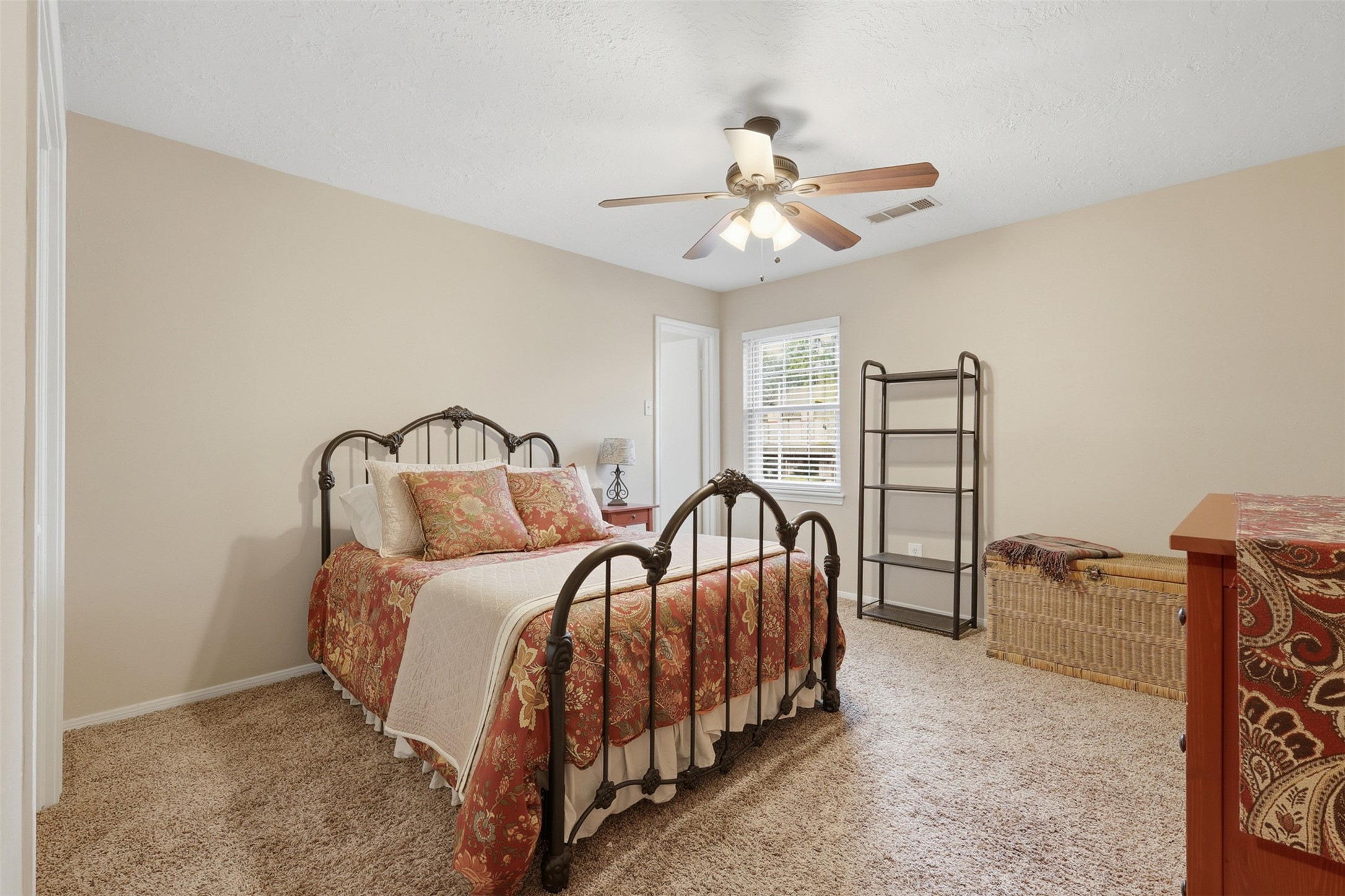 3415 Flickering Candle Drive Spring, TX 77388 - Photo 27 of 36 a bedroom with a bed and a chandelier