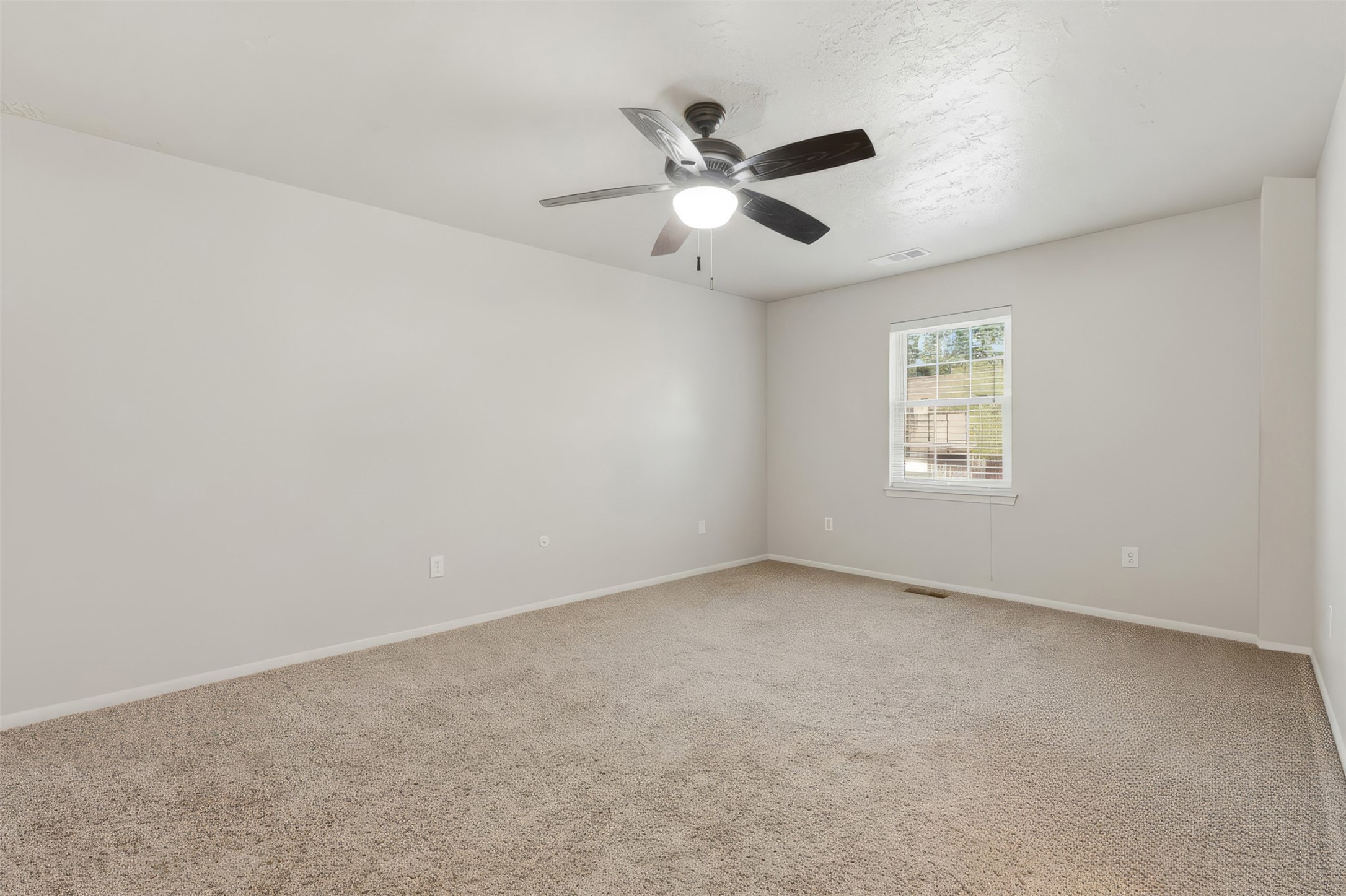 3415 Flickering Candle Drive Spring, TX 77388 - Photo 35 of 36 an empty room with a window and a fan
