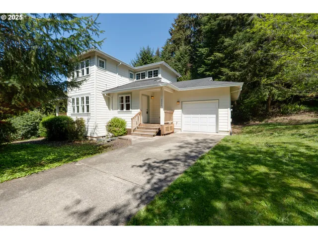a front view of a house with a garden