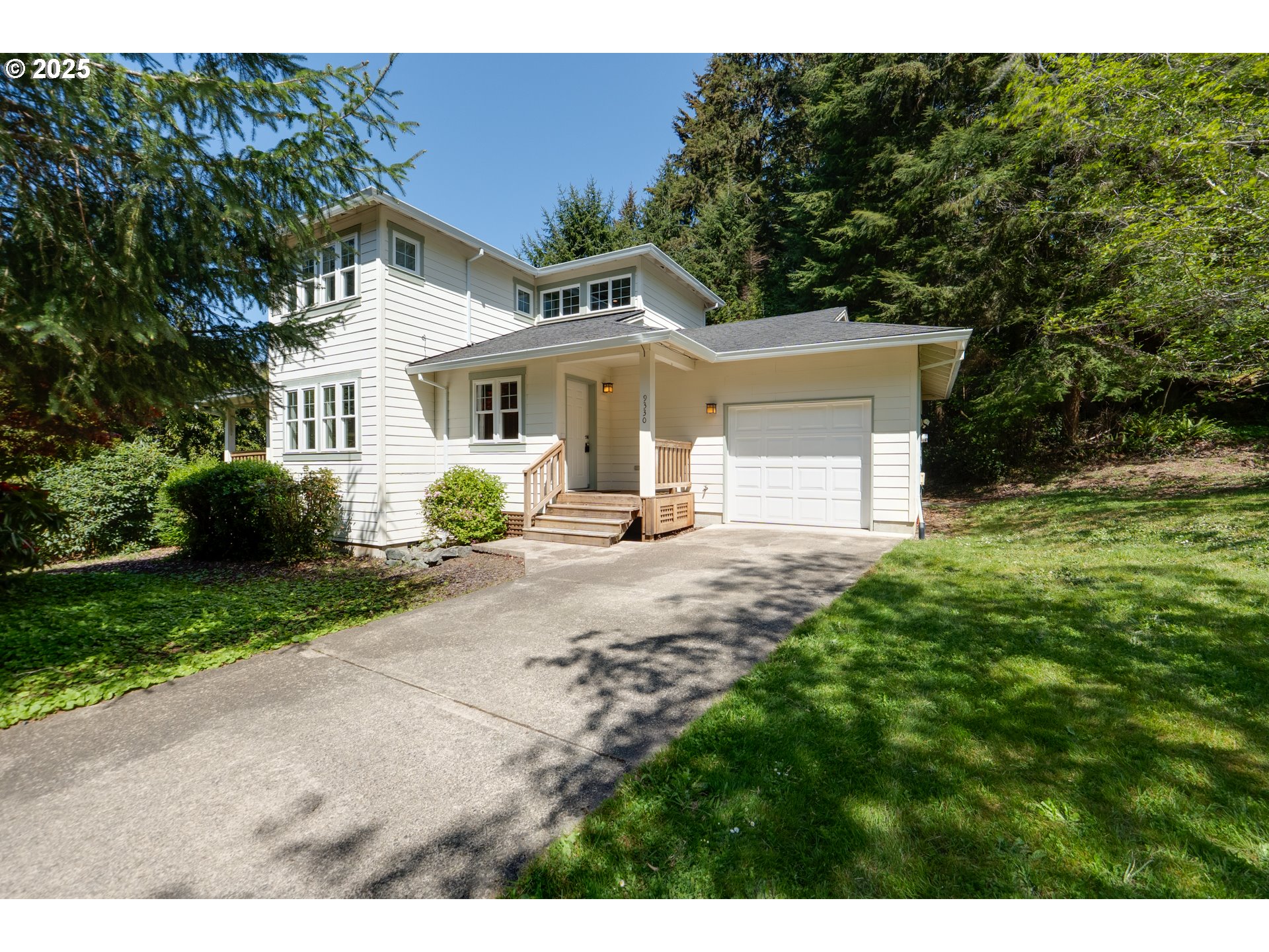 a front view of a house with a garden