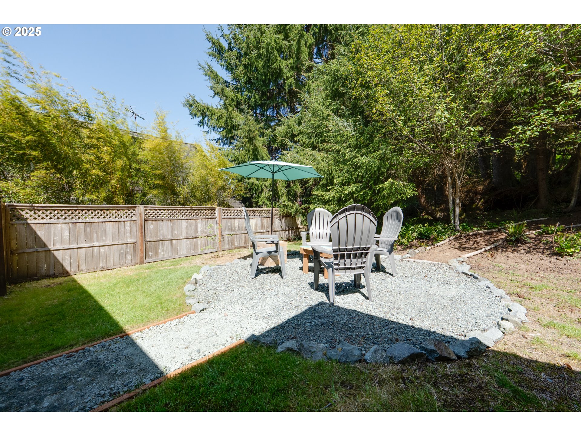 9330 Dewolf Road Nehalem, OR 97131 - Photo 22 of 24 a backyard of a house with table and chairs