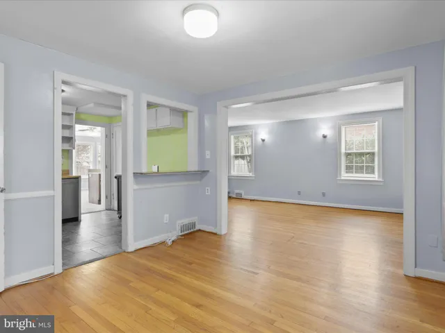 a view of a room with wooden floor and window