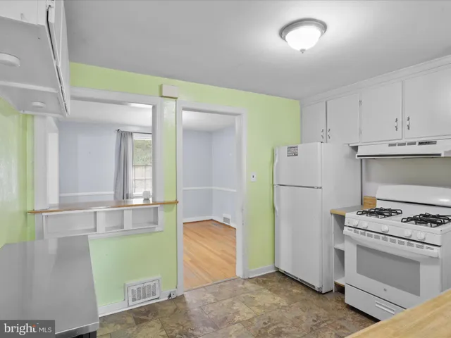 a kitchen with a refrigerator and a stove