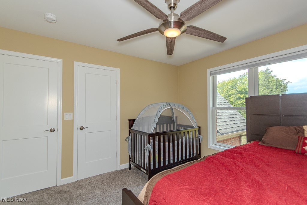 8675 Auburn Road Chardon, OH 44024 - Photo 23 of 35 Carpeted bedroom featuring a crib and a ceiling fan