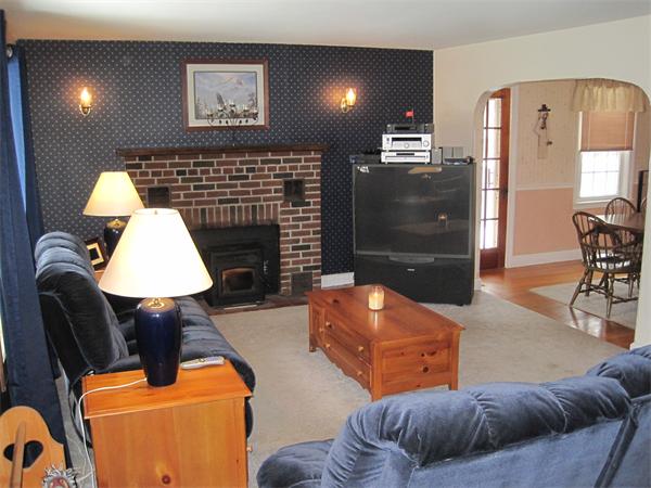 33 Smith Road Sutton, MA 01590 - Photo 11 of 16 a living room with furniture and a fireplace