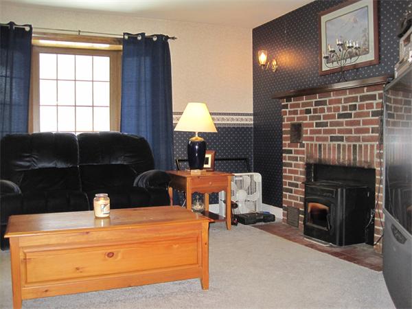 33 Smith Road Sutton, MA 01590 - Photo 10 of 16 a living room with furniture and a fireplace